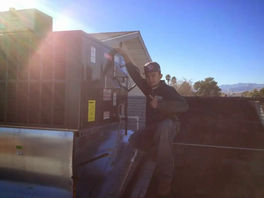 HVAC technician performing Boiler Repair on a rooftop unit in North Sewickley